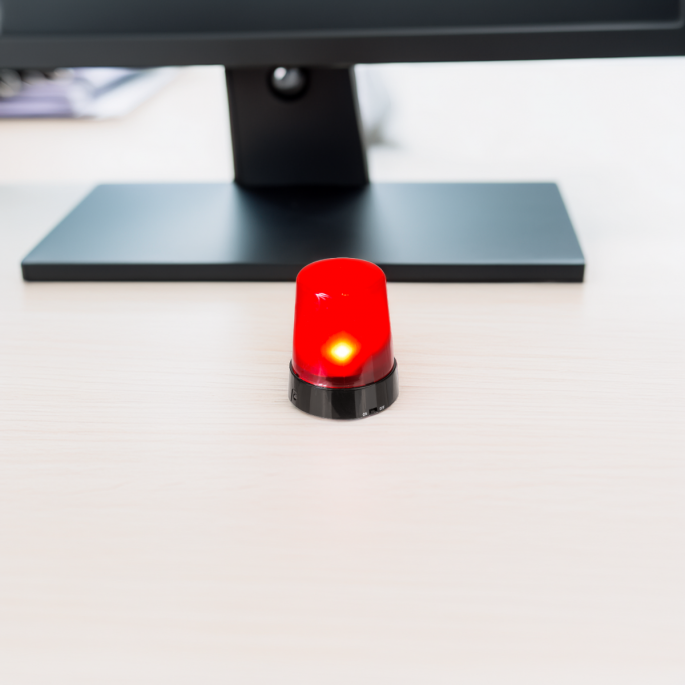 Desktop alarm on a desk with an office background